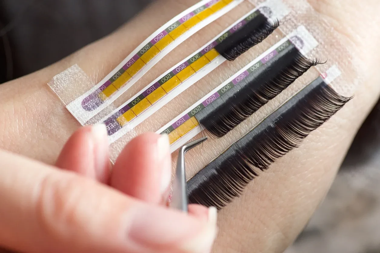 Lash extension strips and tweezers close-up